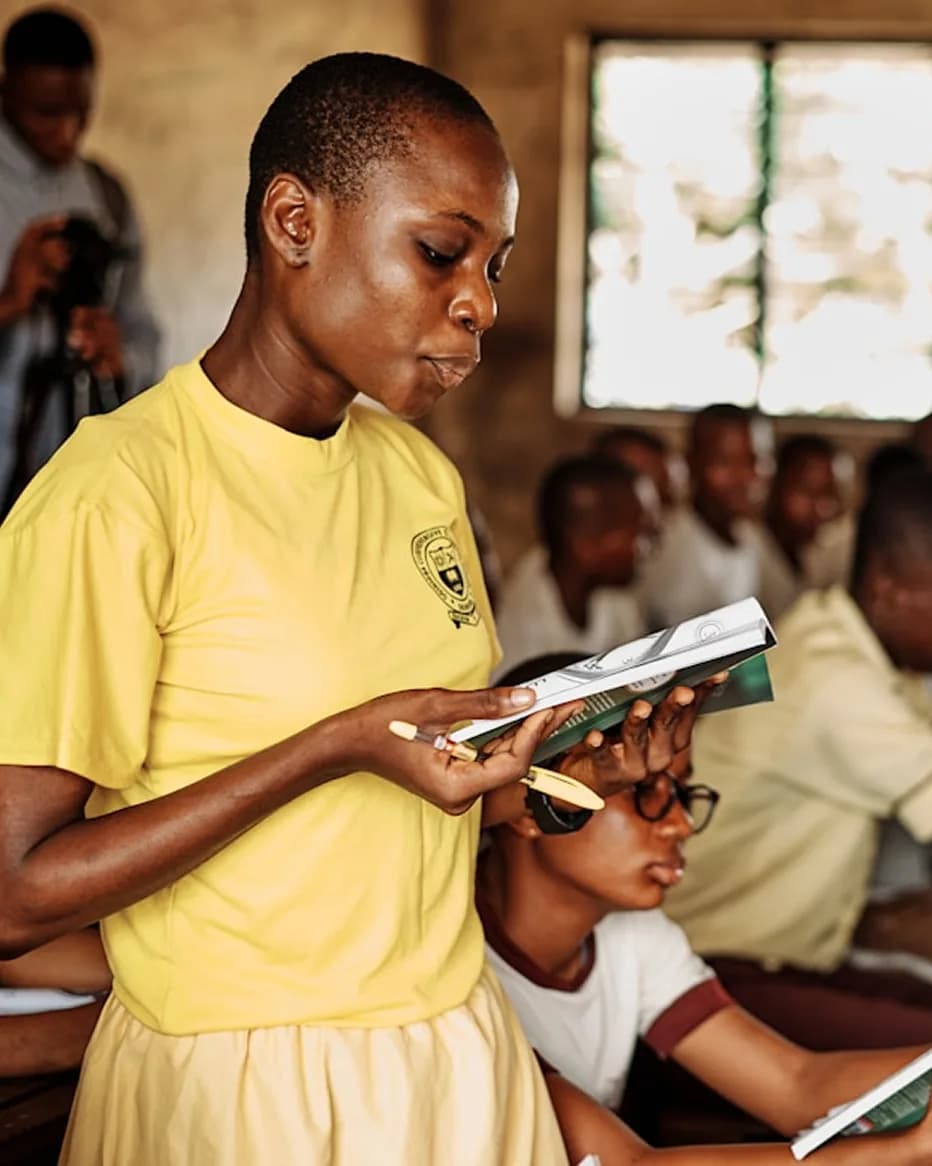 A student reading in class at a partner school